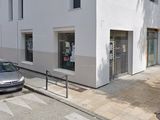 a car parked on the side of the street in front of a building