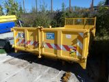 a yellow dump truck that is parked next to a blue truck