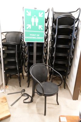 a lot of chairs and a sign in a room