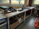 a workbench with a lot of tools on top of it