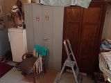 an image of a cluttered room with a ladder and a chair