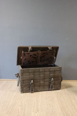 a small wooden chest sitting on the floor next to a wall
