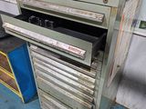 a metal cabinet with a drawer on top of it