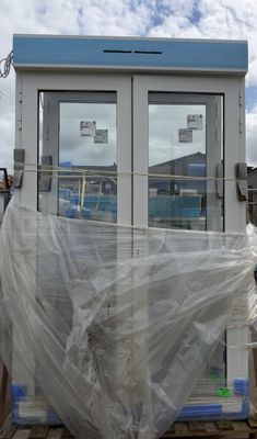a large white building with a lot of plastic covering it