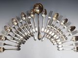 a lot of silver spoons and forks arranged in a circle