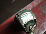 a close up of a green meter on a bench