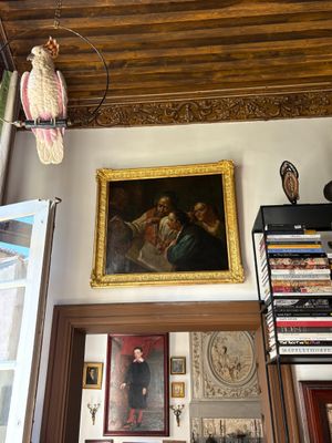a picture of a living room with a bird hanging from the ceiling