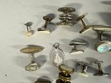 a lot of different types of cuff watches on the table