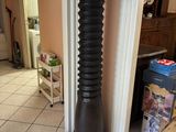 a tall wooden pole in the middle of a room