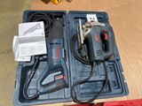 a box with a drill and other tools on a table