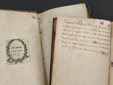 three old books that are open on a table
