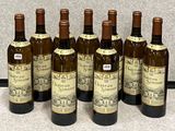 six bottles of wine are lined up in a row on a table