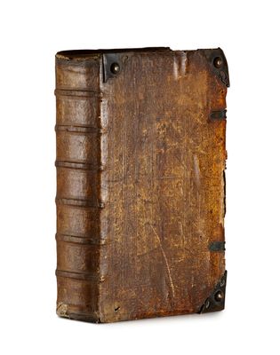 un vieux livre à la couverture en cuir sur fond blanc