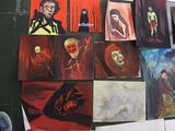 many paintings on the floor of this room
