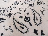 a close up of a black and white paisley print fabric
