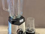 un mixeur posé sur un plan de travail, avec un verre à côté
