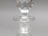 a clear glass bottle with a glass stopper on it