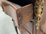 a small wooden table with a drawer on it