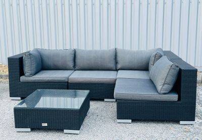 an image of a couch and coffee table in front of a building