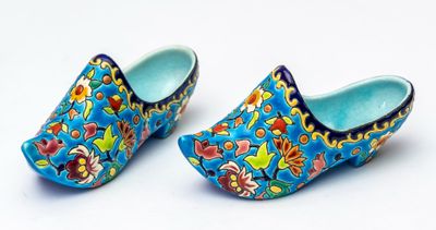 une paire de sabots bleus ornés de motifs floraux colorés