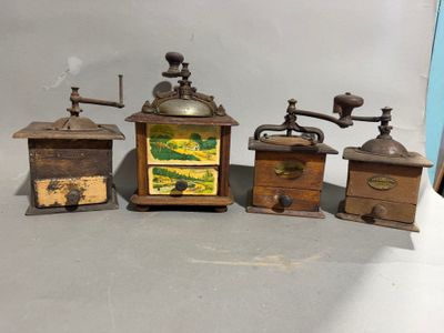 several different types of antique coffee grinders and grinders on a table