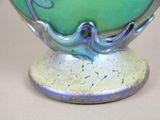 a blue and green vase sitting on top of a table