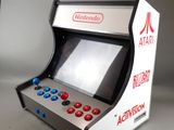 a small video game machine that is sitting on a table