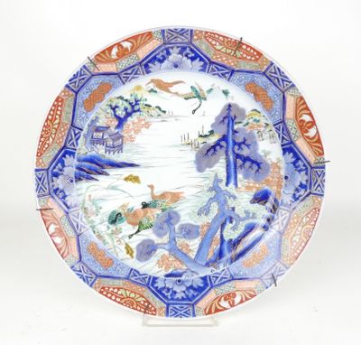 a blue and orange plate with birds and flowers on it