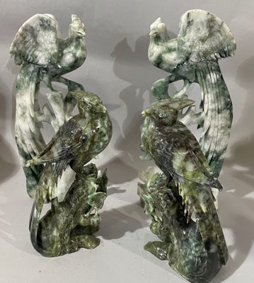 Voici deux statues d'oiseaux perchés sur une branche d'arbre