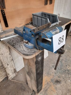 a viset on a workbench with a number on it