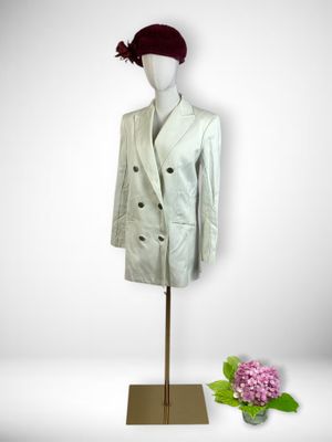 a mannequin wearing a white suit and a red hat
