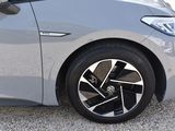 a close up of a car ' s wheel on a gravel road