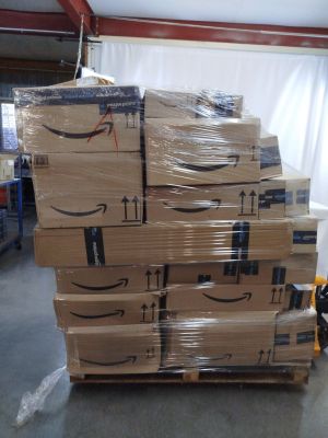 boxes stacked on top of each other on a pallet in a warehouse