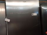 several stainless steel refrigerators are lined up in a warehouse