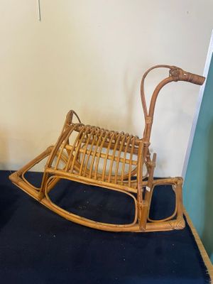 un fauteuil à bascule en bois posé sur un tapis bleu