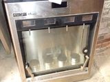 a silver oven sitting in the middle of a room