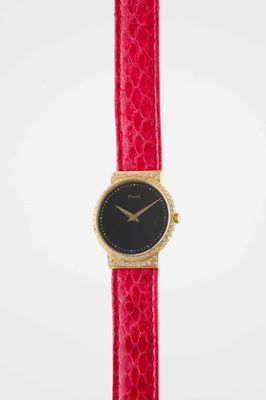 a close up of a red watch on a white background