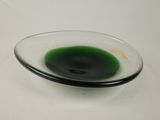 a black substance in a glass bowl on a white table