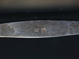 a close up of a knife on a black surface