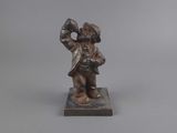 figurine of a man with a hat and coat on a base