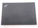 the back of a laptop with a black cover sitting on a white surface
