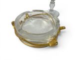 a glass ashtray with a gold rim on a white background