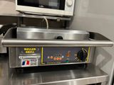 stainless steel counter top with oven and microwave on it in a commercial kitchen
