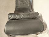 a black leather chair that is sitting in a room