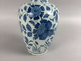 a blue and white vase with blue flowers on it