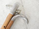a pair of old walking canes on a white surface