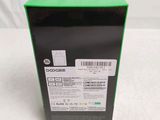 the back of a box with a green lid on a white surface