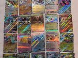 a pile of pokemon cards sitting on top of a table