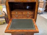 a wooden desk with a leather pad on top of it