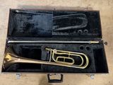 a brass trumpet in a case on the floor